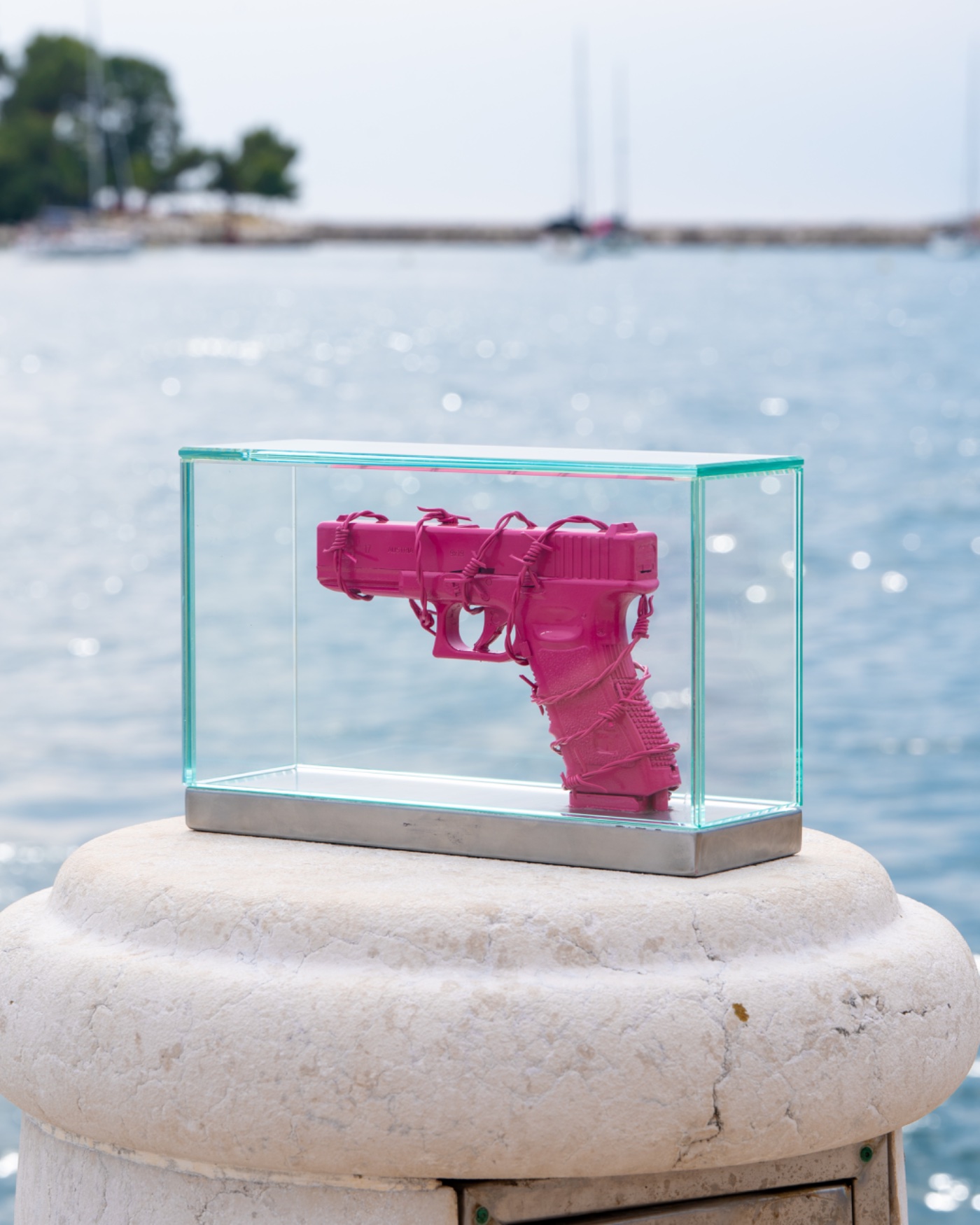 DISARMED N&deg;0 in glass vitrine on a harbour bollard